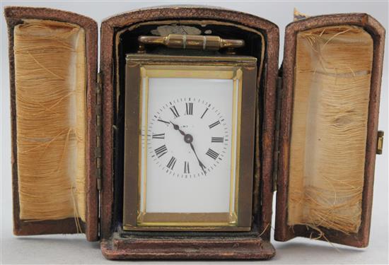 An early 20th century brass miniature carriage timepiece, 2.5in. in travelling case